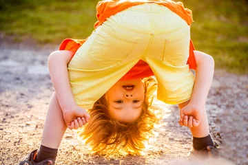 Foto op Plexiglas Child playing. Freedom of self expression and behaviour for kids. Happy cute child standing upside down. Playing fools kid. Young man happy positive smile playful fooling dance. Cute boy having fun © Yevhen