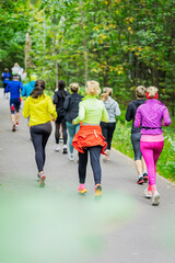 Healthy youth group jogging at park, back view. Sports lifestyle