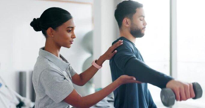 Woman, support and dumbbells for patient in physiotherapy, muscle training or rehabilitation help. Man, athlete and physiotherapist in sports clinic for okay physical therapy and weight achievement