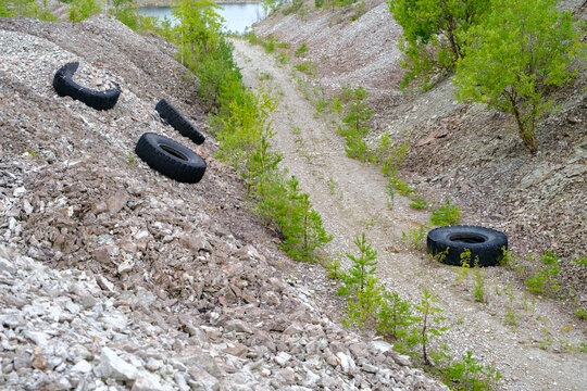 Four old tires, which were illegally dumped on dirt, were thrown away. Dolomite quarries with waste. Environmentally unfriendly. Aidu quarry, Estonia