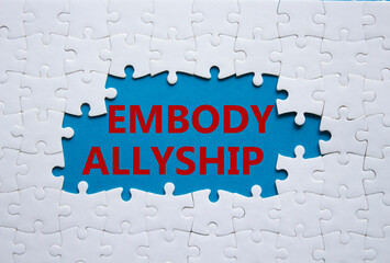 Embody Allyship symbol. Concept word Embody Allyship on white puzzle. Beautiful blue background. Business and Embody Allyship concept. Copy space