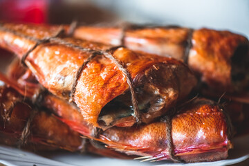smoked fish sea bass on the table. homemade smoking
