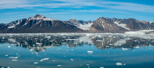 Stunning landscapes with jagged mountain peaks, glaciers and icebergs along the shores of the...