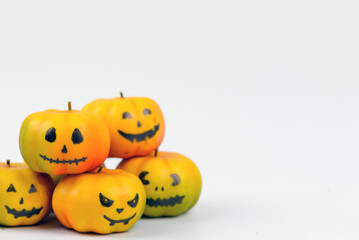 Halloween pumpkin decor with funny faces on a white background with space for text