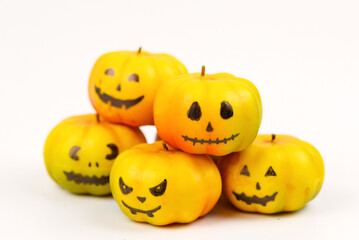 Halloween pumpkin decor with funny faces on a white background with space for text
