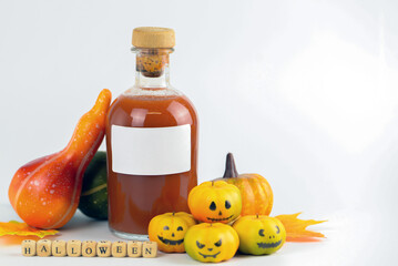 Halloween decor with pumpkins, blood, lantern and candles on a white background with space for text