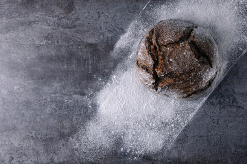 Rye bread on the table in flour round