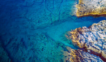 Drone perspective of beautiful rocky beach with turquoise sea water at the Korcula island, Croatia during first morning light