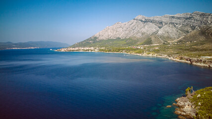 Fototapeta na wymiar St. Elijah mountain rising high above town of Orebic on Peljesac peninsula, overlooking island of Korcula in the distance, photographed with drone