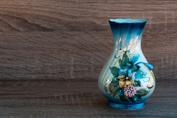a horizontal shot of a one white-blue vase decorated flowers without natural flowers in it on light...