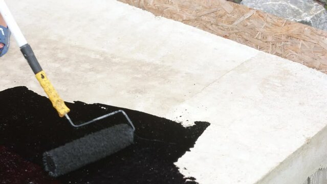 Water proofing concept of the concrete or foundation of the new house, hydro isolation of the concrete, industrial concept