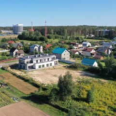 Finished freshly built private house, ready for occupancy of tenants with an undeveloped plot. House built on sand. Modern architecture of a private house.