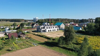 Finished freshly built private house, ready for occupancy of tenants with an undeveloped plot. House built on sand. Modern architecture of a private house.