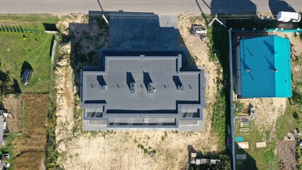  Contemporary architecture of private housing. Flat roof, rectangular cottage. Aerial view from a drone of a freshly built country house, cottage from above. 
