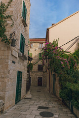 Fototapeta na wymiar Charming alley with flowers in old town Split, Dalmatia, Croatia