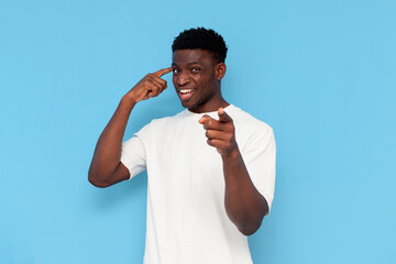 you are stupid. African guy in white T-shirt points with his hand at the camera and holds his...