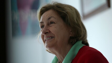 Happy senior woman nodding yes in affirmation while listening to conversation, candid elderly lady...