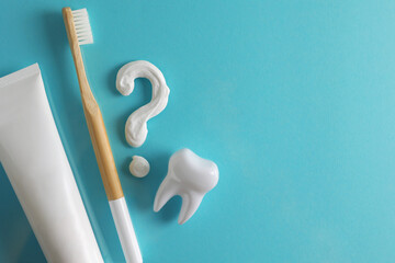 Toothpaste question mark on a colored background. Dental care, oral health. - obrazy, fototapety, plakaty