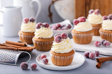 Spiced cinnamon and cranberry cupcakes topped with sugared cranberries for Christmas or Thanksgiving