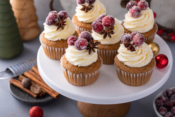 Spiced cinnamon and cranberry cupcakes topped with sugared cranberries for Christmas or Thanksgiving