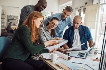Multigenerational diverse group of architects working together on a project in a startup company...