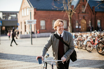 Middle aged businessman commuting to work with a bicycle