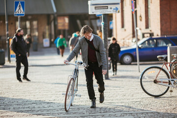 Middle aged businessman commuting to work with a bicycle