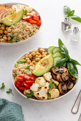 Healthy high protein vegan plant based lunch bowl with mushrooms, roasted cauliflower, chickpeas and quinoa