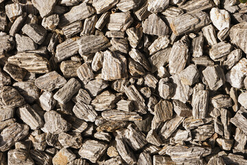 Gravel texture. Small rocks grain pattern for graphic design. Little stones background. Gray noise backdrop. Fence facade texture. White decorative stones. Decorative stones background.