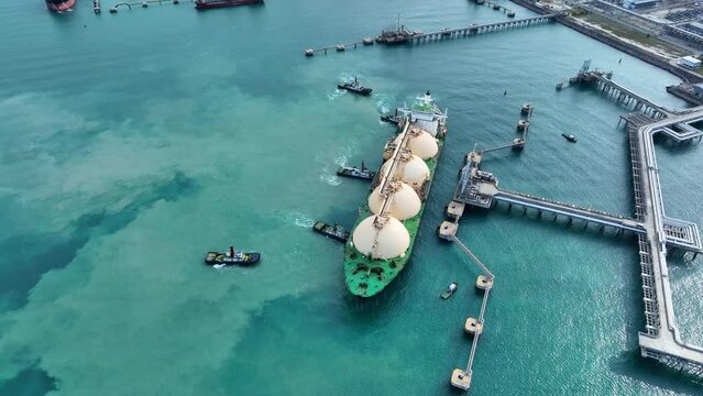 LNG (Liquified Natural Gas) tanker anchored in Gas terminal gas tanks for storage. Oil Crude Gas Tanker Ship. LPG at Tanker Bay Petroleum Chemical or Methane freighter export import transportation and