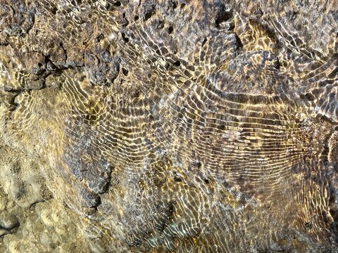 Sea underwater seabed water aqua ripples pebbles stones.