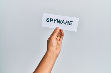 Hand of caucasian man holding paper with spyware word over isolated white background