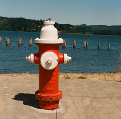 Bright red and white fire hydrant along the bay