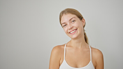 Fototapeta premium Young blonde woman smiling confident standing over isolated white background
