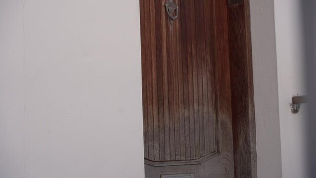 The cat sleeps on the threshold at the front door.