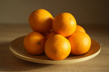 Several juicy oranges in a plate