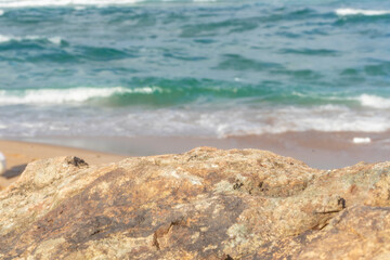 A beautiful presentation area for product placements. Clear rocks in the front, sunny sea and air in the background.