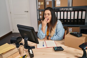 Young beautiful plus size woman ecommerce business worker yawning at office