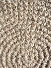Crocheting of jute, yarn, raffia white in a circle close-up as a background