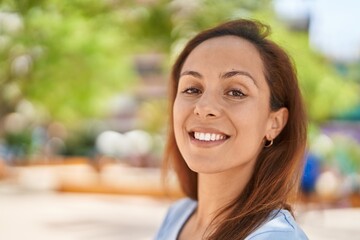 Young woman smiling confident standing at park