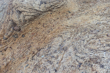 Background image of details on the rock seen straight ahead.