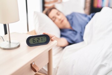 Middle age woman lying on bed sleeping at street