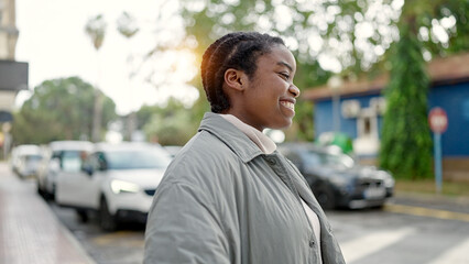 Fototapeta premium African american woman smiling confident looking to the side at street