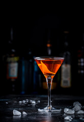 Bobby Burns strong cocktail drink with scotch whiskey, vermouth and liquor in martini glass, dark bar counter background