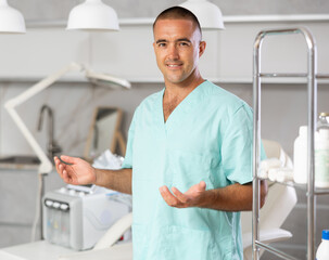 Beside cosmetology chair, physician standing near professional hydrogen oxygen facial machine.
