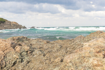 A beautiful presentation area for product placements. Clear rocks in the front, sunny sea and air in the background.