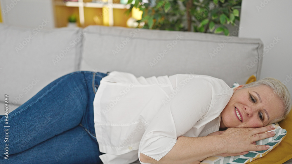 Canvas Prints Middle age grey-haired woman lying on sofa sleeping at home