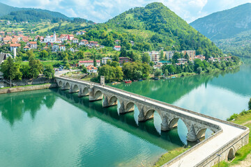 Mehmed Pasa Sokolovic Bridge over Drina river with city panorama, Visegrad, Bosnia