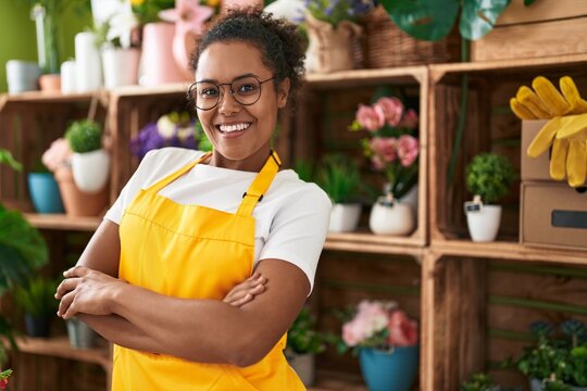 African american woman florist smiling confident standing with arms crossed gesture at flower shop