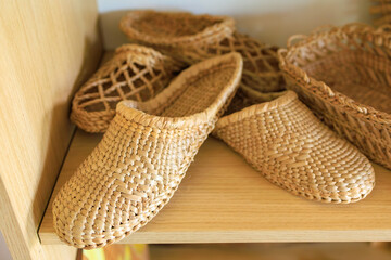 Woven straw slippers. Background with selective focus and copy space